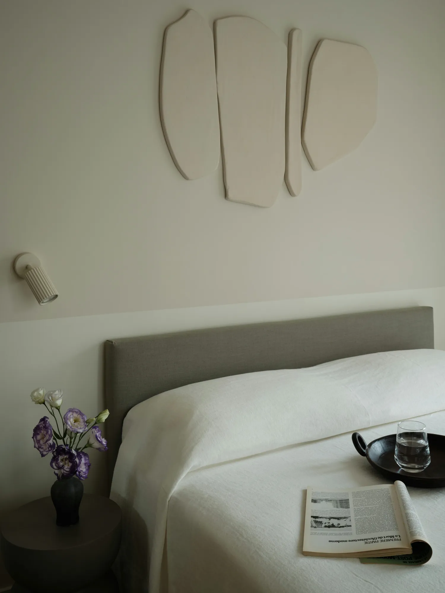 Bedside detail with wall-mounted reading light
