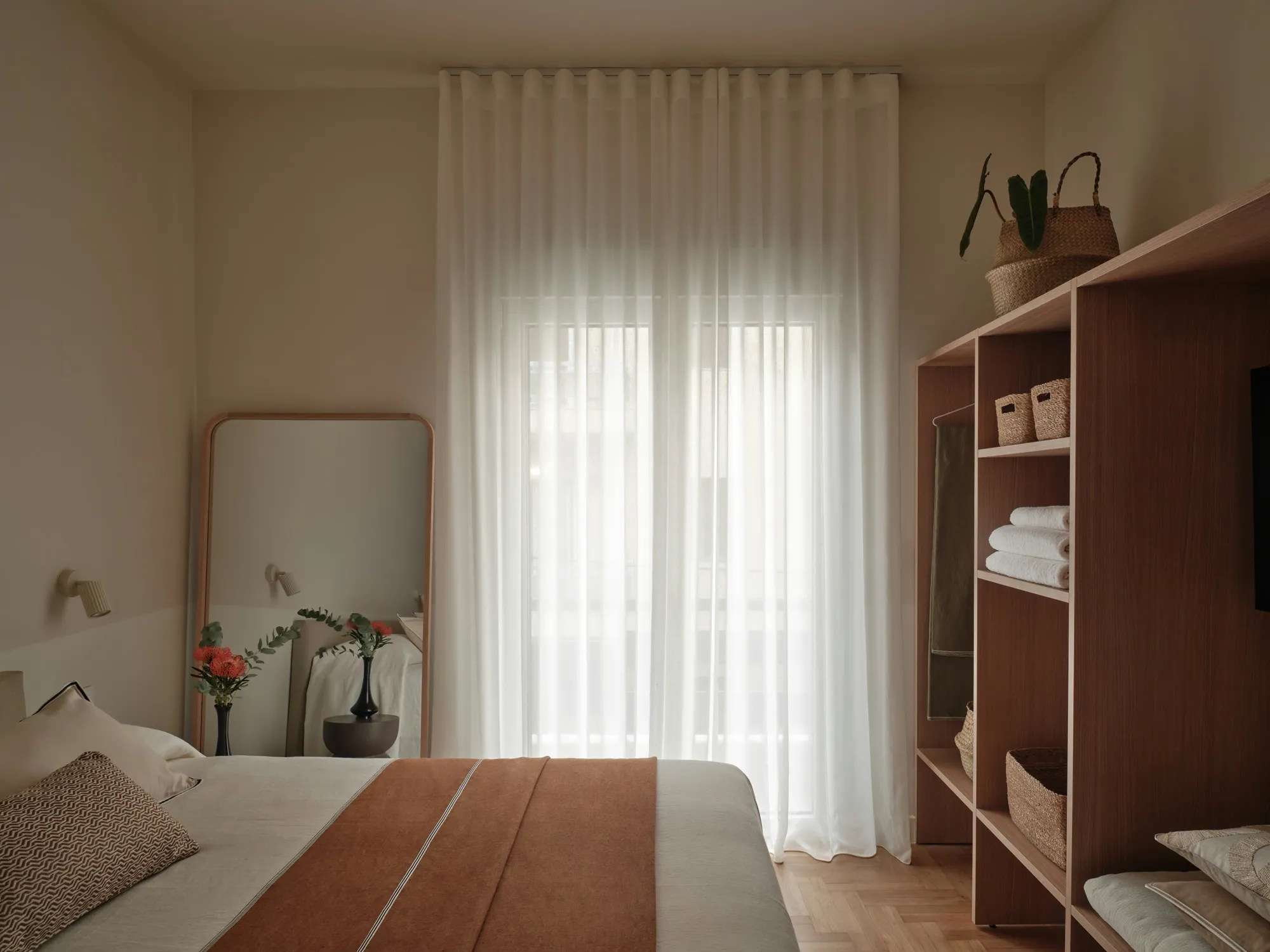 Second bedroom facing a softly curtained window