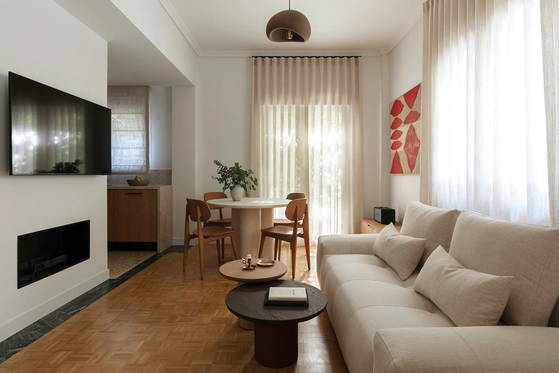 Open living and dining room with fireplace and view into the timber kitchen
