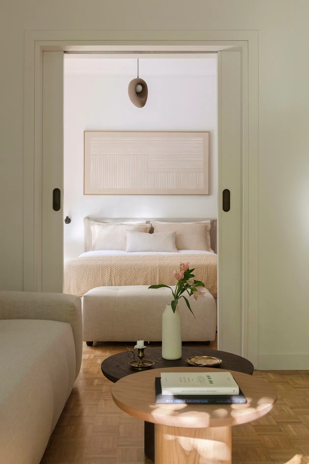 Bedroom framed by sliding doors from the living room