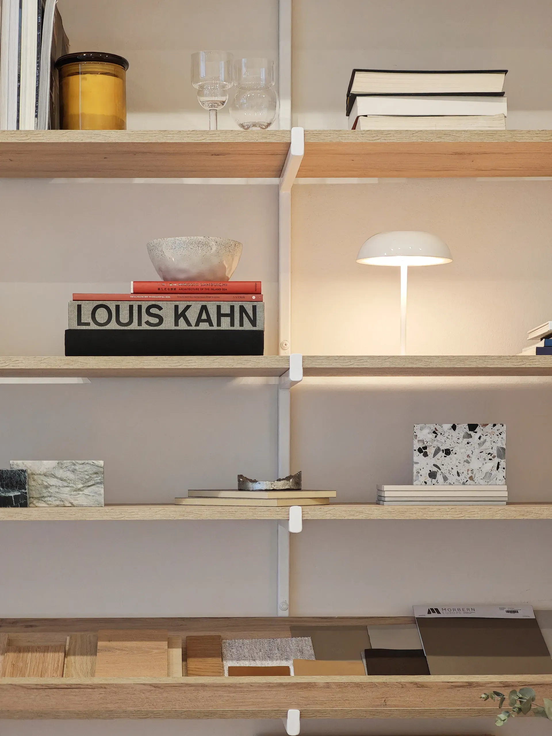 Architecture books, lamp and stone samples on the studio shelving