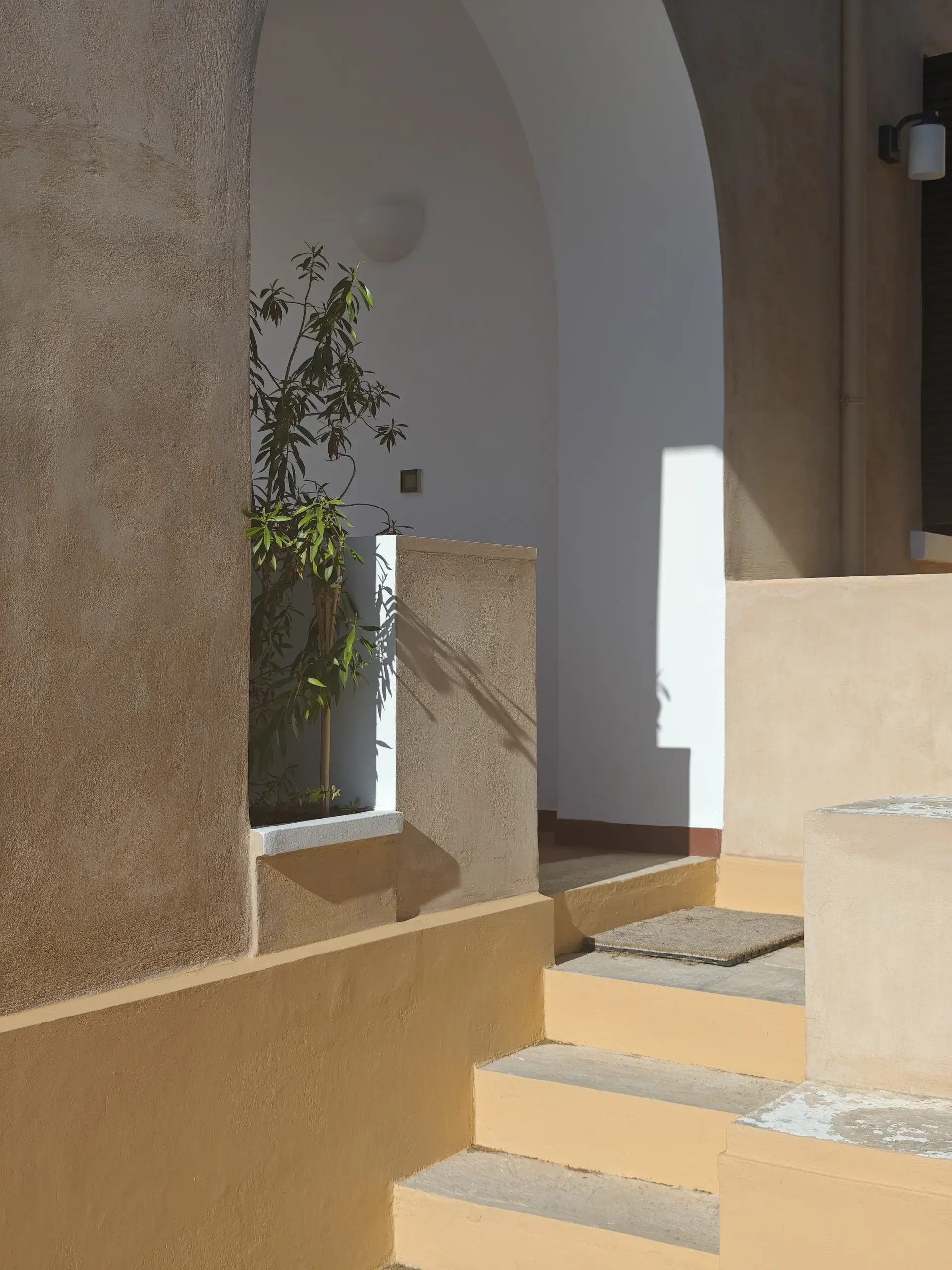 Existing stepped exterior passage with curved rendered walls