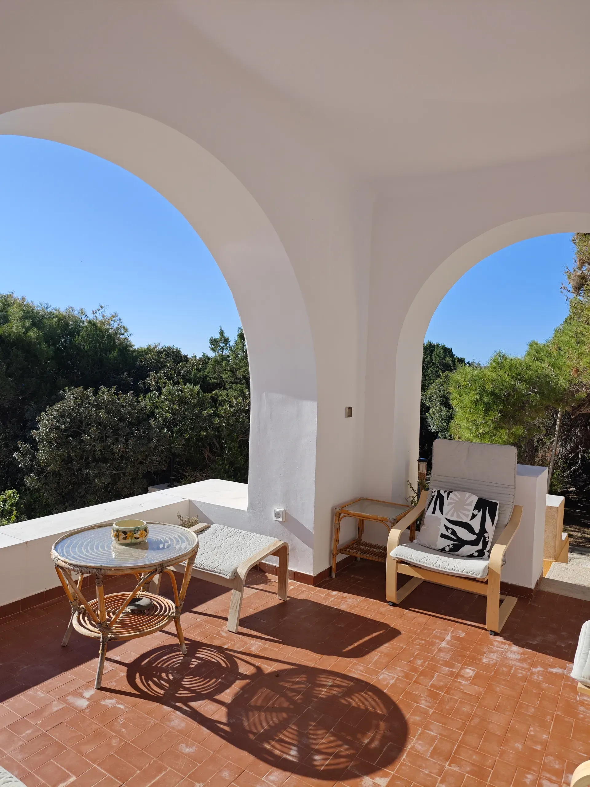 Existing tiled terrace beneath broad white arches