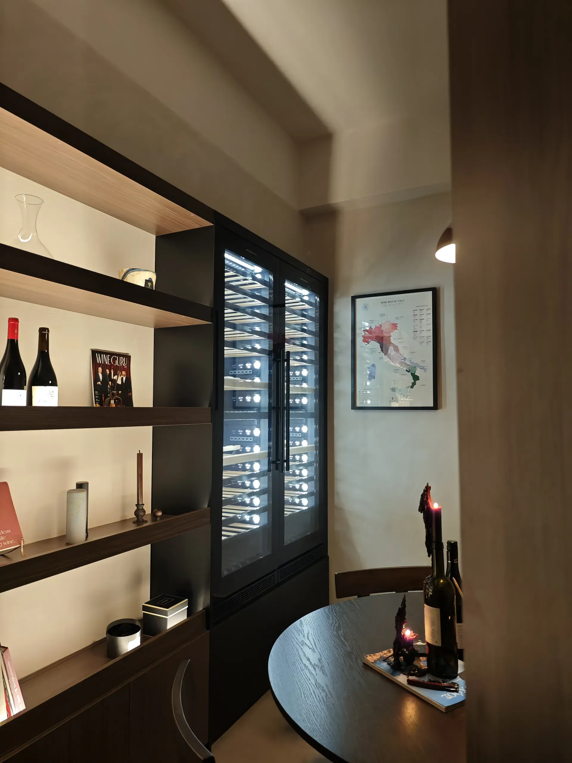 Open display shelving and wine refrigerators beside the round tasting table