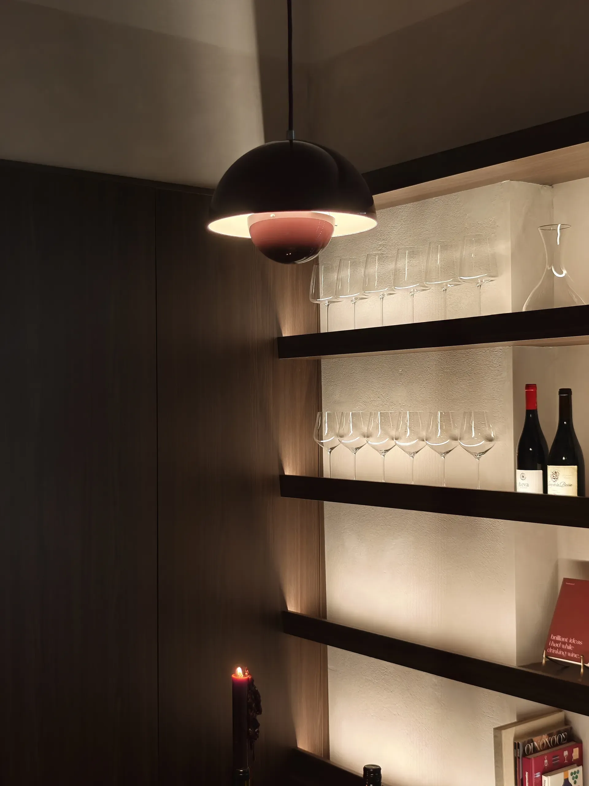 Pendant light and illuminated shelving displaying wine glasses and bottles