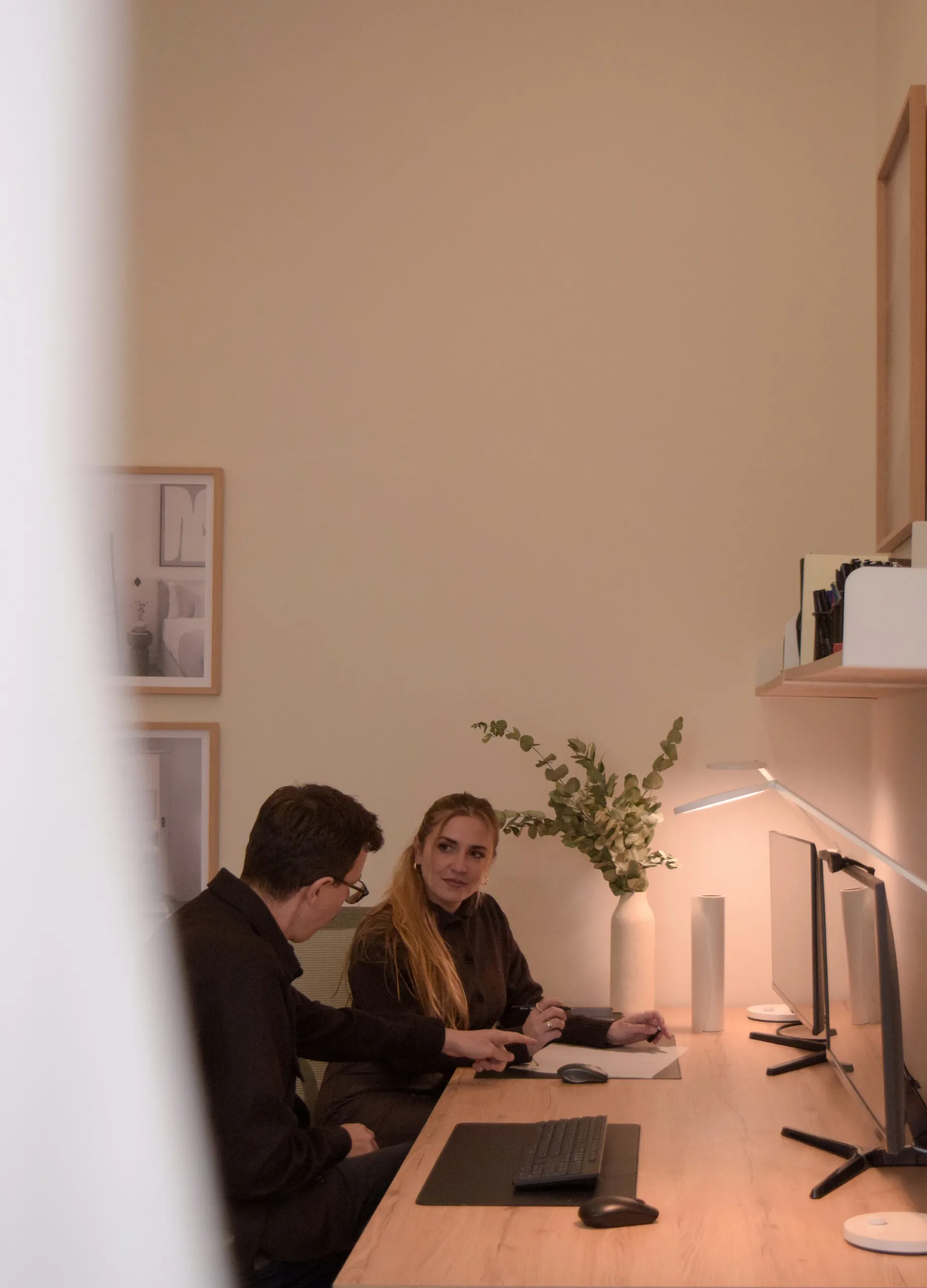 Fineline Studio architects discussing drawings at their Glyfada workspace