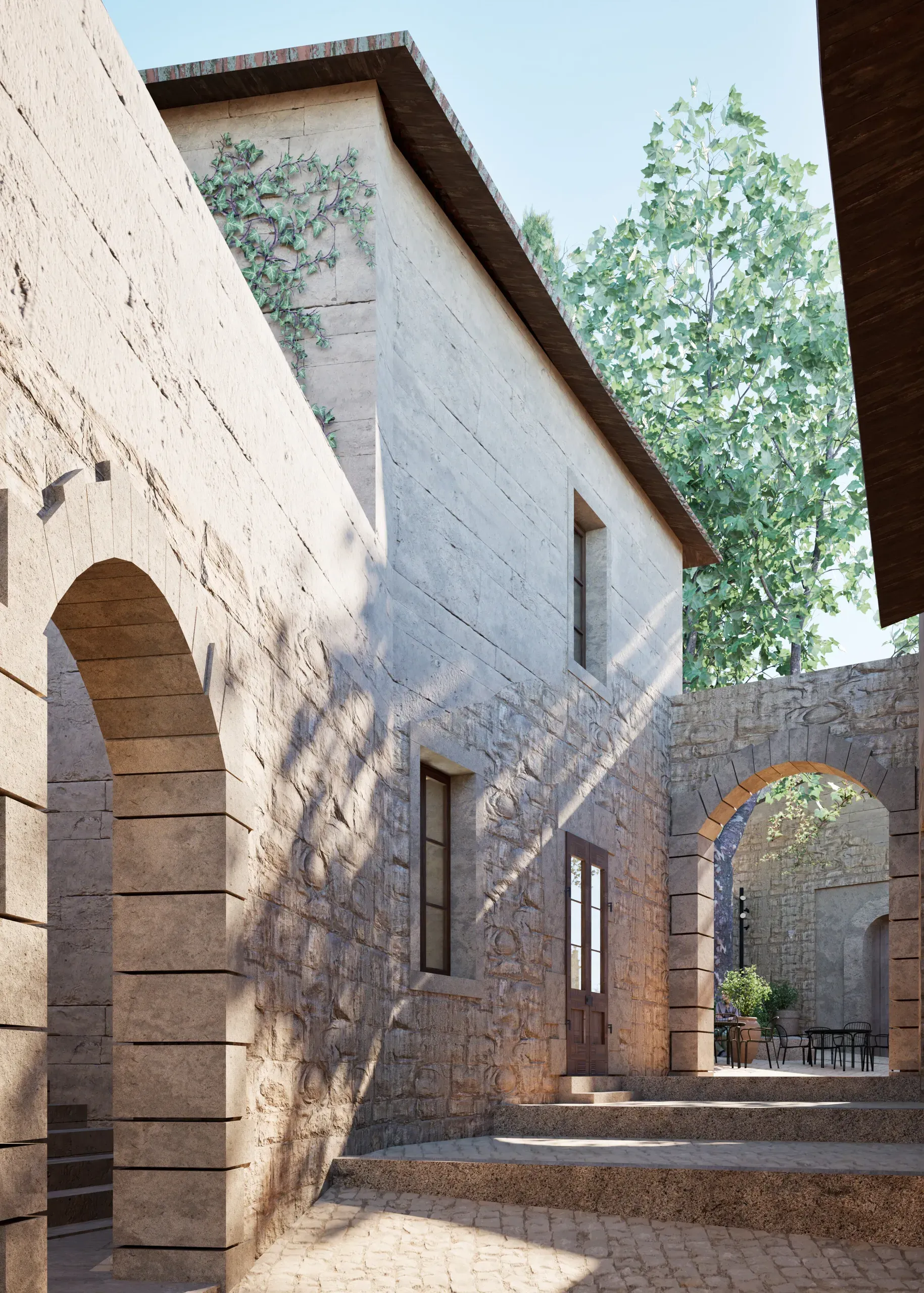 Restored stone buildings and arched passages around a planted courtyard