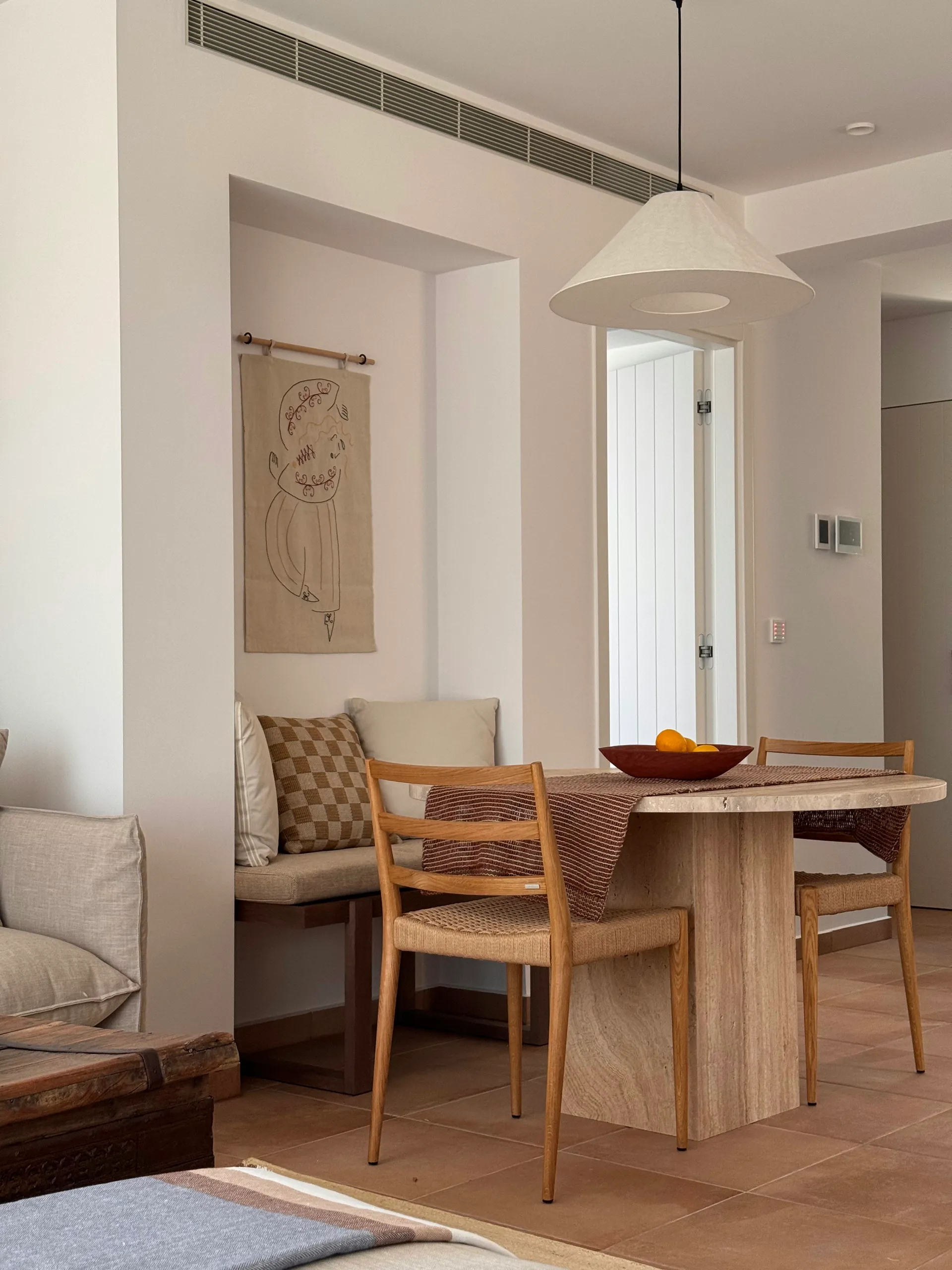 Circular Travertino Beige dining table in a bright interior